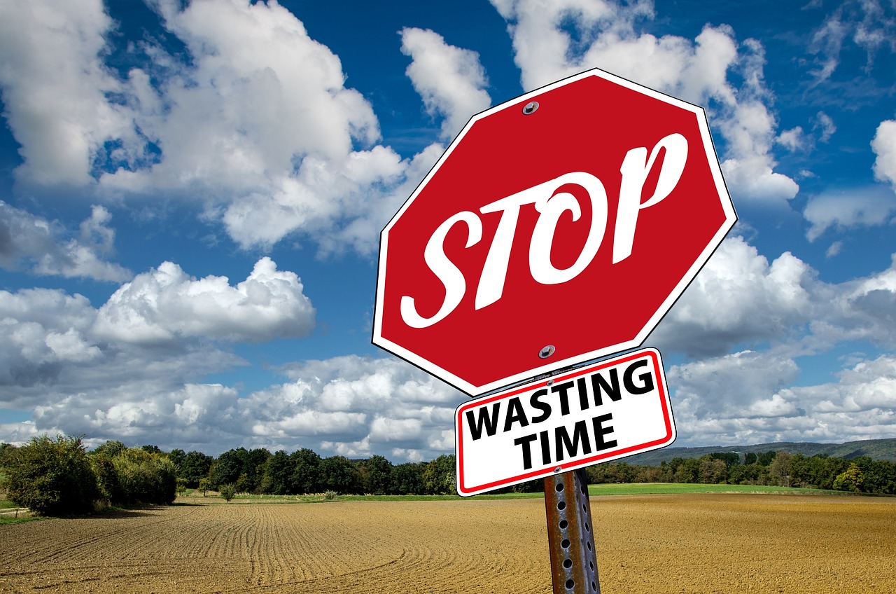 Stop sign that says "Stop wasting time." Discover what's holding you back from meeting your goals.